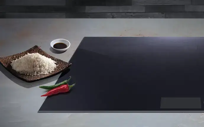 SCHOTT CERAN® glass-ceramic cooktop with rice and chilis on the side