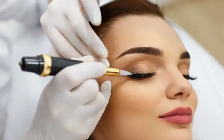 Female having permanent make-up applied to her eye