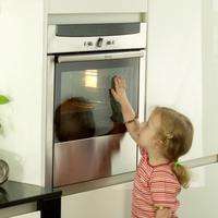 Child touching the outside of an oven
