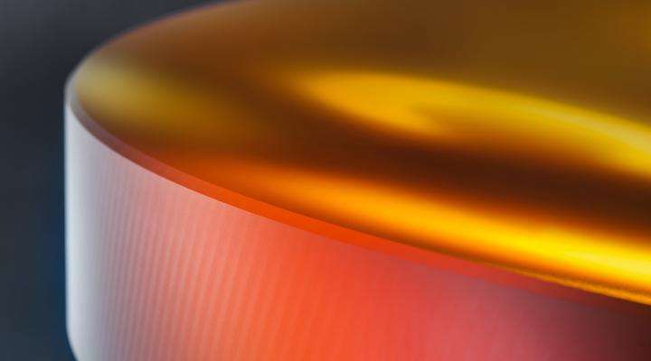 Close up of an orange disc of ZERODUR® glass-ceramic by SCHOTT