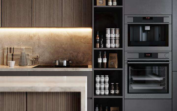 Section of a modern kitchen featuring a built-in oven and coffee machine