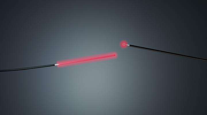 SCHOTT® Luminous Cylindrical Diffuser and Spherical Diffuser emitting red light on a dark background