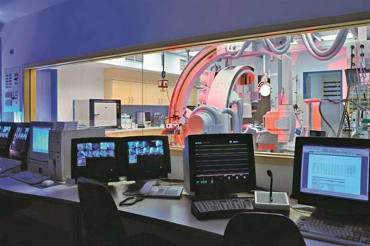 Control room of a medical scan facility behind radiation shielding glass