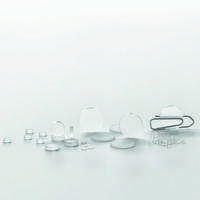 A selection of small clear glass discs of different sizes