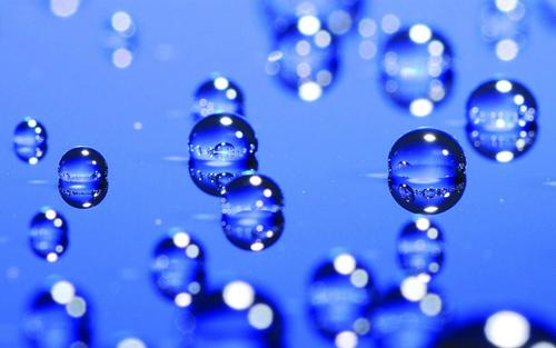 Droplets of water on a blue glass panel