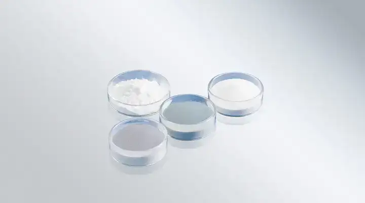 Range of white and grey glass powders in clear glass dishes