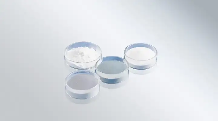 Range of white and grey glass powders in clear glass dishes