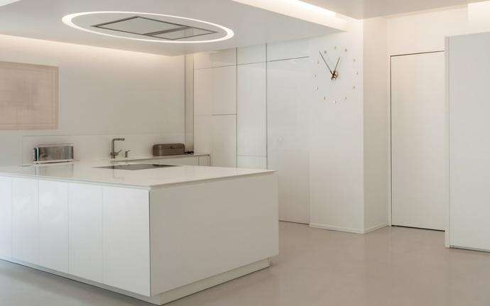 White modern kitchen with hidden appliances and displays