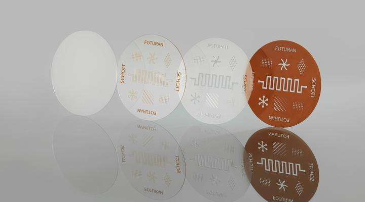 Four discs of SCHOTT FOTURAN® II glass showing the processing steps