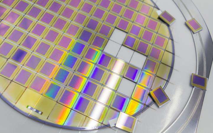 Silicon wafer with microchips in a steel frame holder with separate microchips