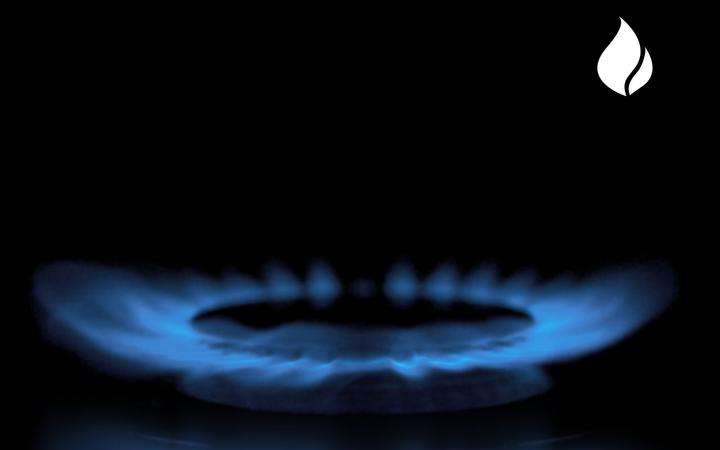 Blue gas flame reflection on the SCHOTT CERAN® glass-ceramic surface and gas flame icon