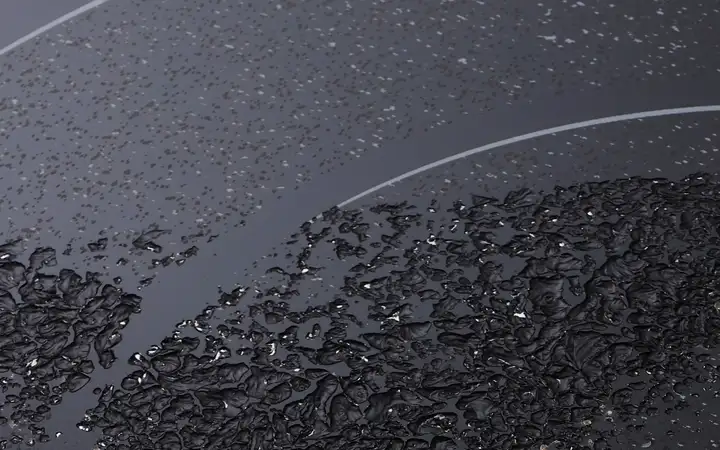 Conchoidal fractures caused by sugar burned onto a glass-ceramic cooking surface