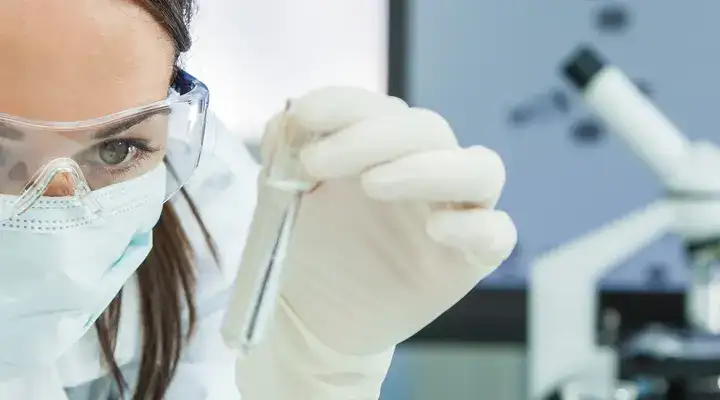 Female scientist examining a test tube in a laboratory