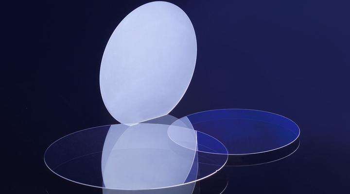 Three circular SCHOTT glass wafers on a blue background
