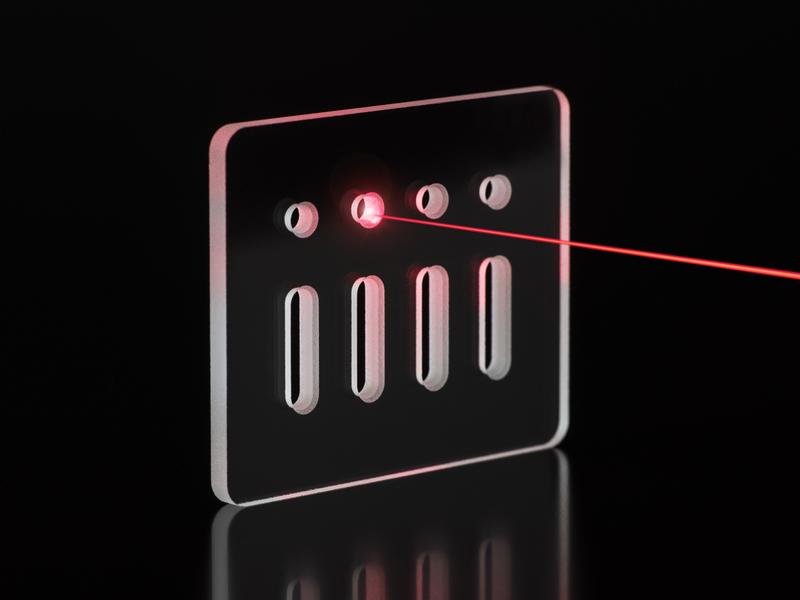 Transparent glass panel with a series of holes and cut-outs by laser processing