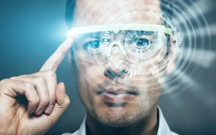 Man wearing and touching a pair of augmented reality glasses