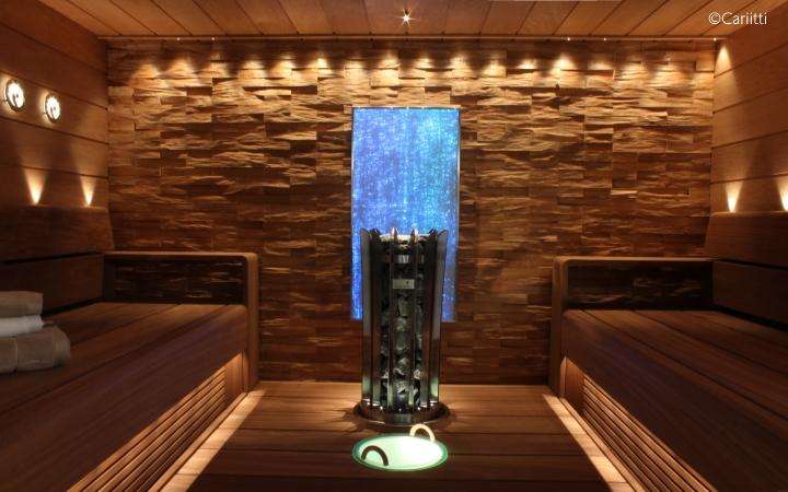 Interior of a wood and stone sauna, with blue light