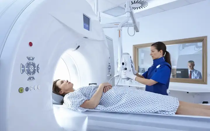 Patient in a CT diagnostic scanner using X-ray bulbs	